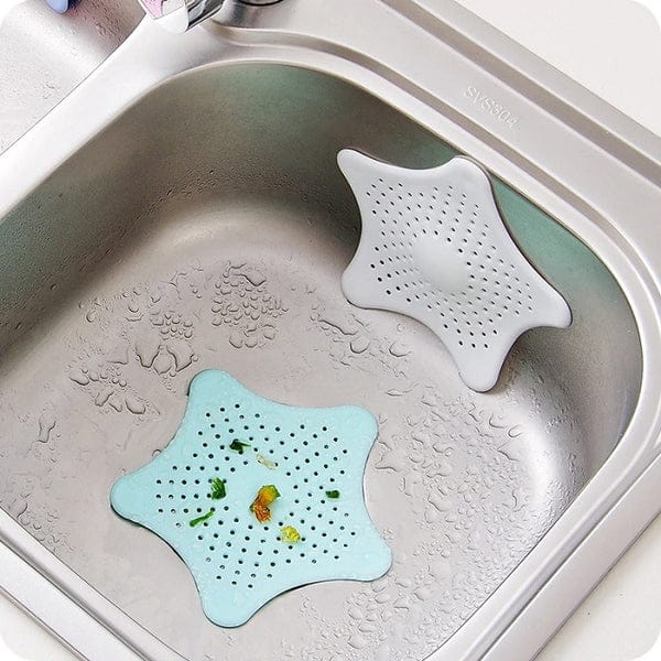 Star-shaped silicone sink strainers in a kitchen sink.