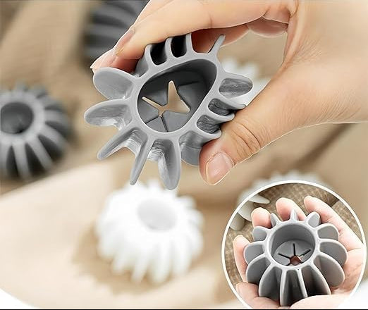 Gray laundry detergent pod held by a hand with product features listed above.