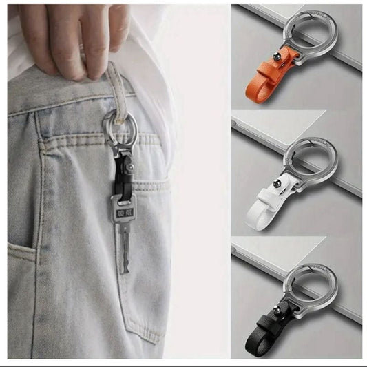 A collage showing a keychain lock attachment in multiple views and color options. The product is a metal ring clip with a strap and a small keychain attached.