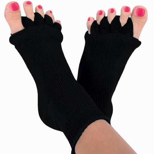 Black toe separators worn on toes with pink nail polish on a white background