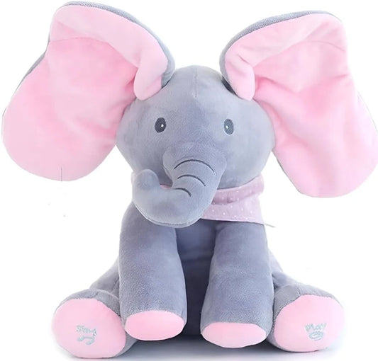 A plush elephant toy in soft gray and pink, sitting upright against a plain white background. The toy has very large floppy pink ears, a pink inner ear lining, a pink trunk, a pink polka-dot bow, and pink feet with small embroidered details.