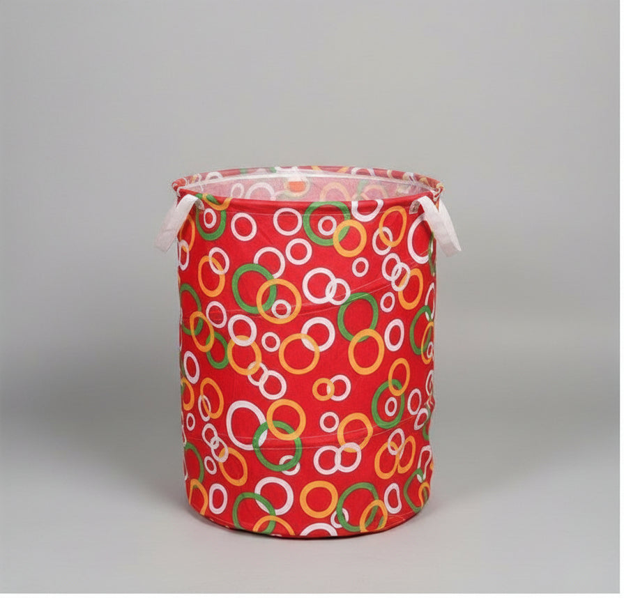 A collage showing a large laundry bag from multiple angles on a white background, with a black label at the bottom reading 'BIG LAUNDRY BAG.' The bag has a red base with an allover pattern of overlapping rings in white, green, yellow, and orange.