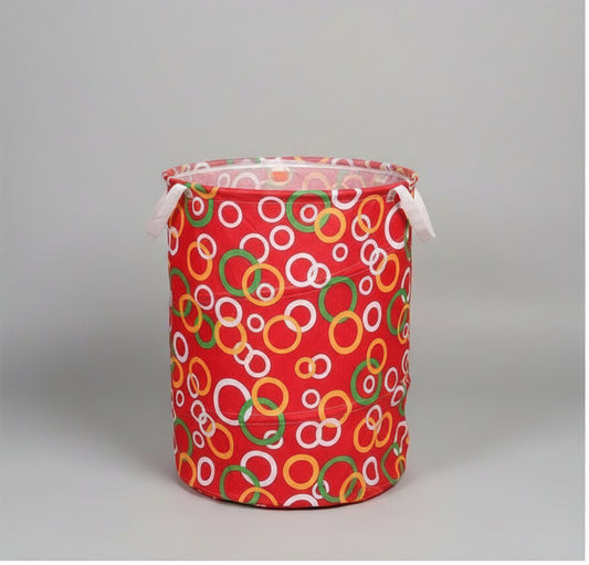 A collage showing a large laundry bag from multiple angles on a white background, with a black label at the bottom reading 'BIG LAUNDRY BAG.' The bag has a red base with an allover pattern of overlapping rings in white, green, yellow, and orange.
